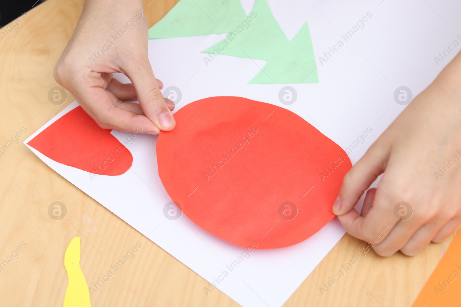 Photo of Girl making art project at table indoors, closeup