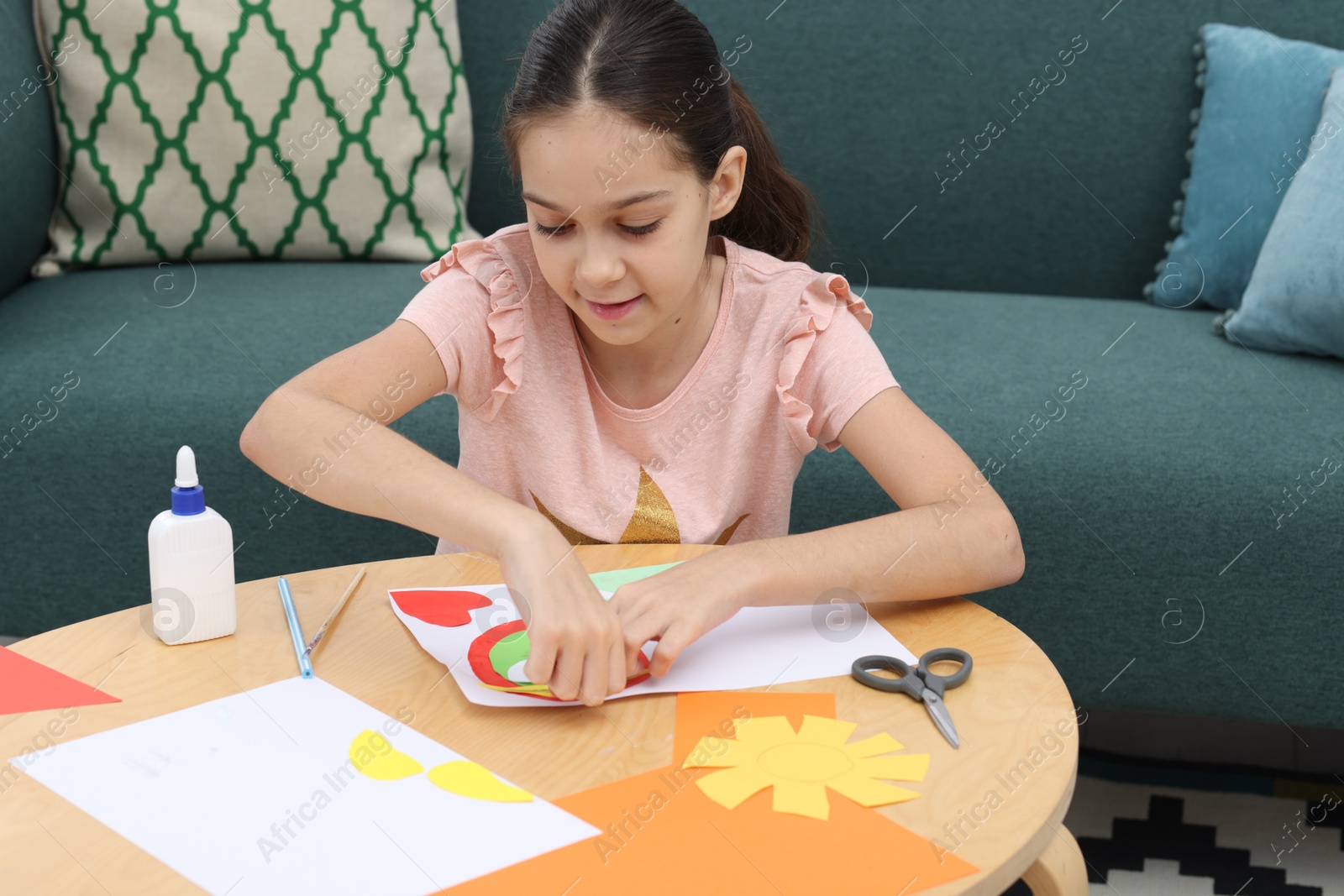 Photo of Girl making art project at table indoors