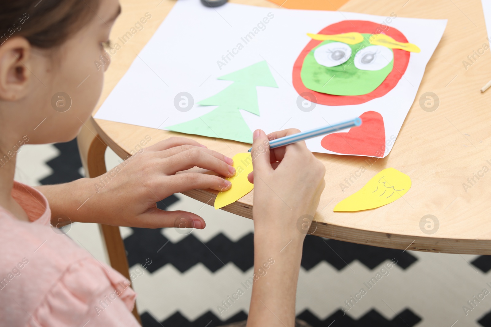 Photo of Girl drawing card at table indoors, closeup. Art and craft