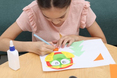 Photo of Girl drawing card at table indoors, closeup. Art and craft