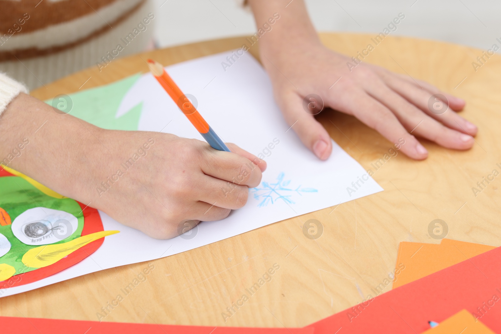 Photo of Girl drawing card at table indoors, closeup. Art and craft