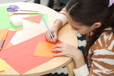 Photo of Girl drawing card at table indoors. Art and craft