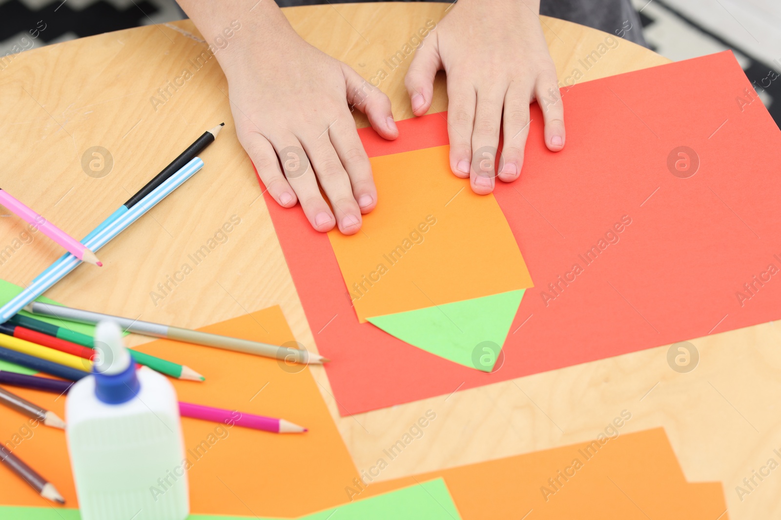 Photo of Girl making art project at table indoors, closeup