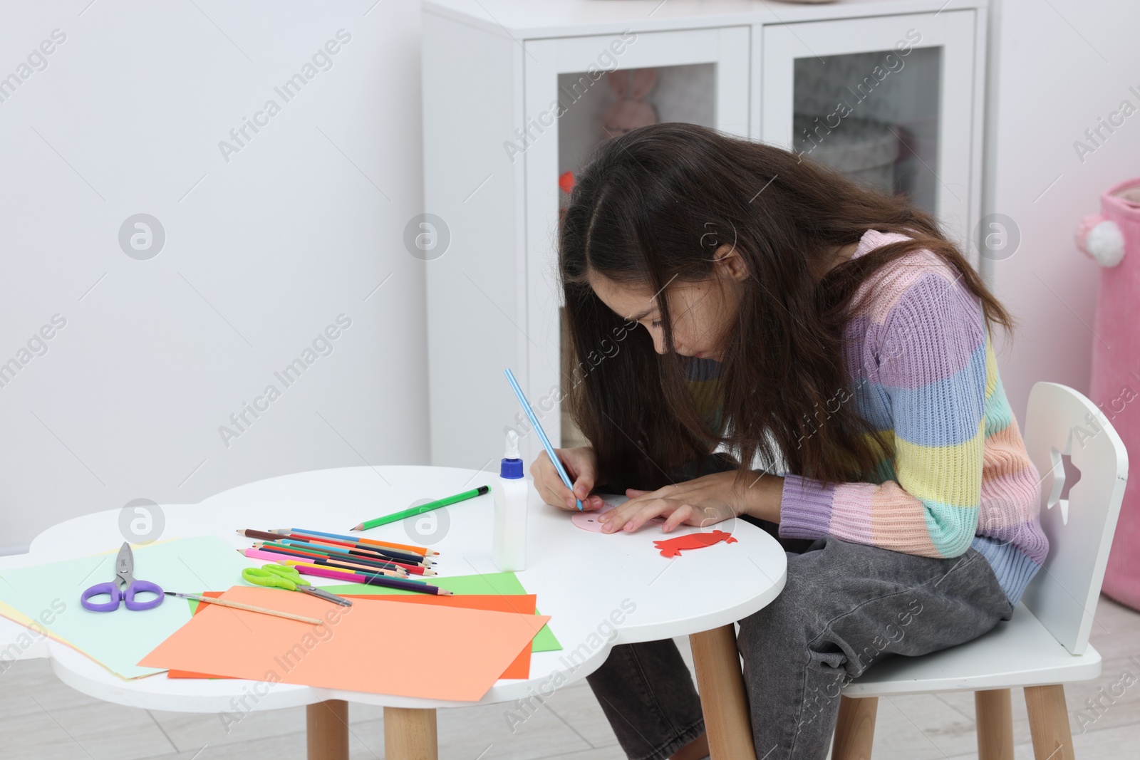 Photo of Girl drawing card at table indoors, space for text. Art and craft