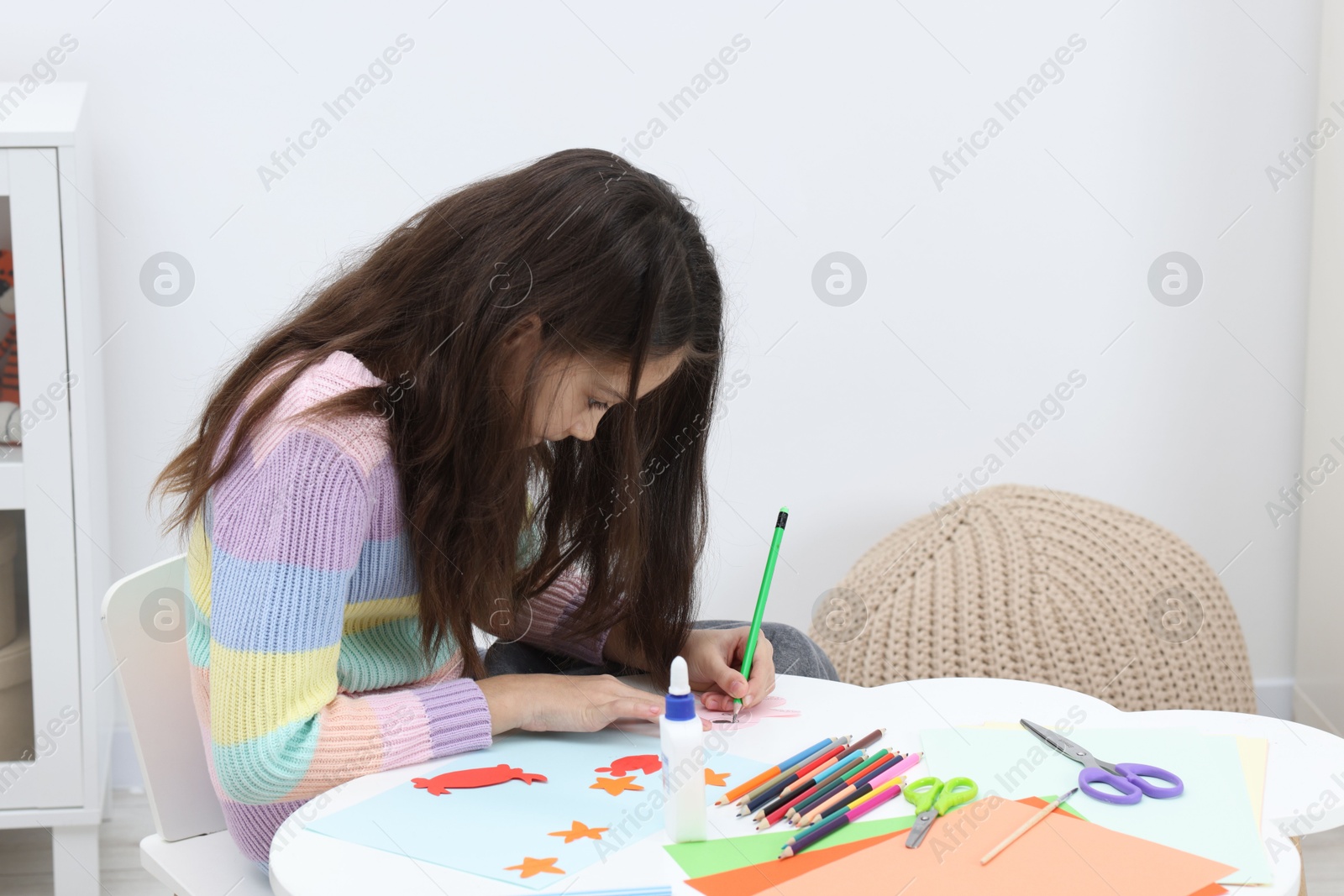 Photo of Girl drawing card at table indoors, space for text. Art and craft