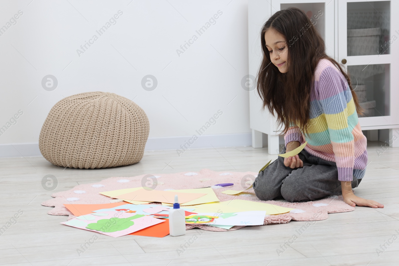 Photo of Girl making art project at home. Space for text