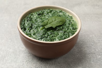 Delicious spinach sauce in bowl on grey table, closeup