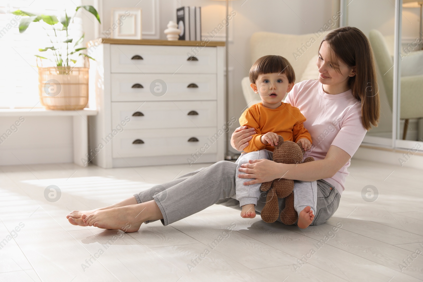 Photo of Happy mother with her little son at home