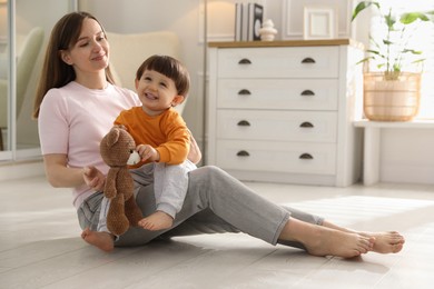 Photo of Happy mother with her little son at home