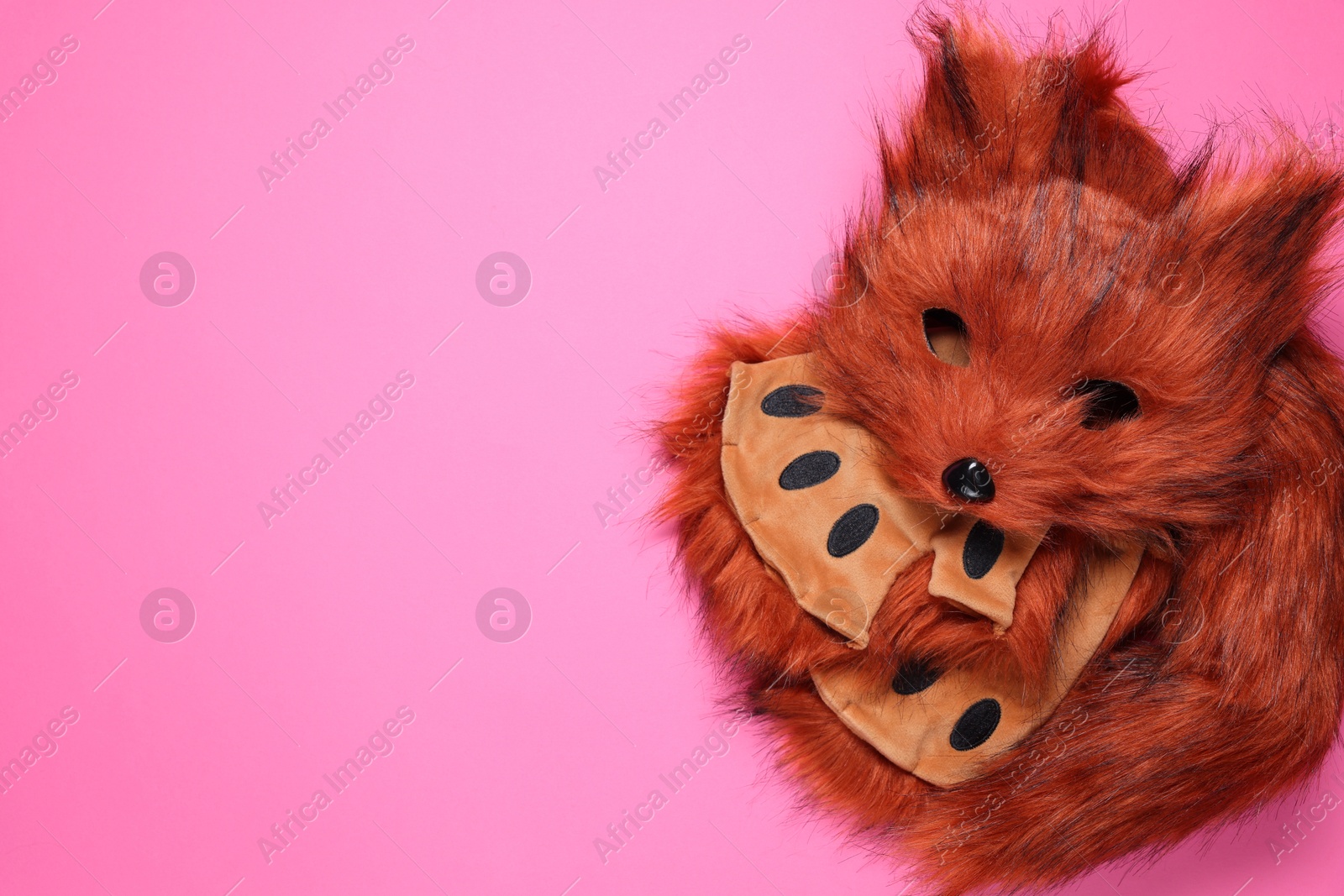 Photo of Quadrobics. Fox mask, gloves and tail on pink background, top view. Space for text