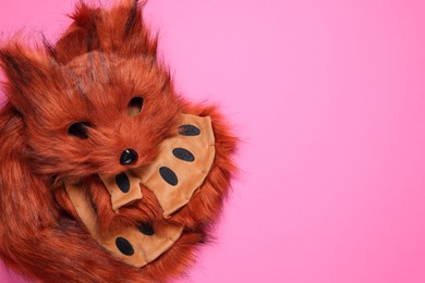 Photo of Quadrobics. Fox mask, gloves and tail on pink background, top view. Space for text