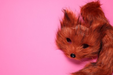 Photo of Quadrobics. Fox mask and tail on pink background, top view. Space for text