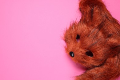 Photo of Quadrobics. Fox mask and tail on pink background, top view. Space for text