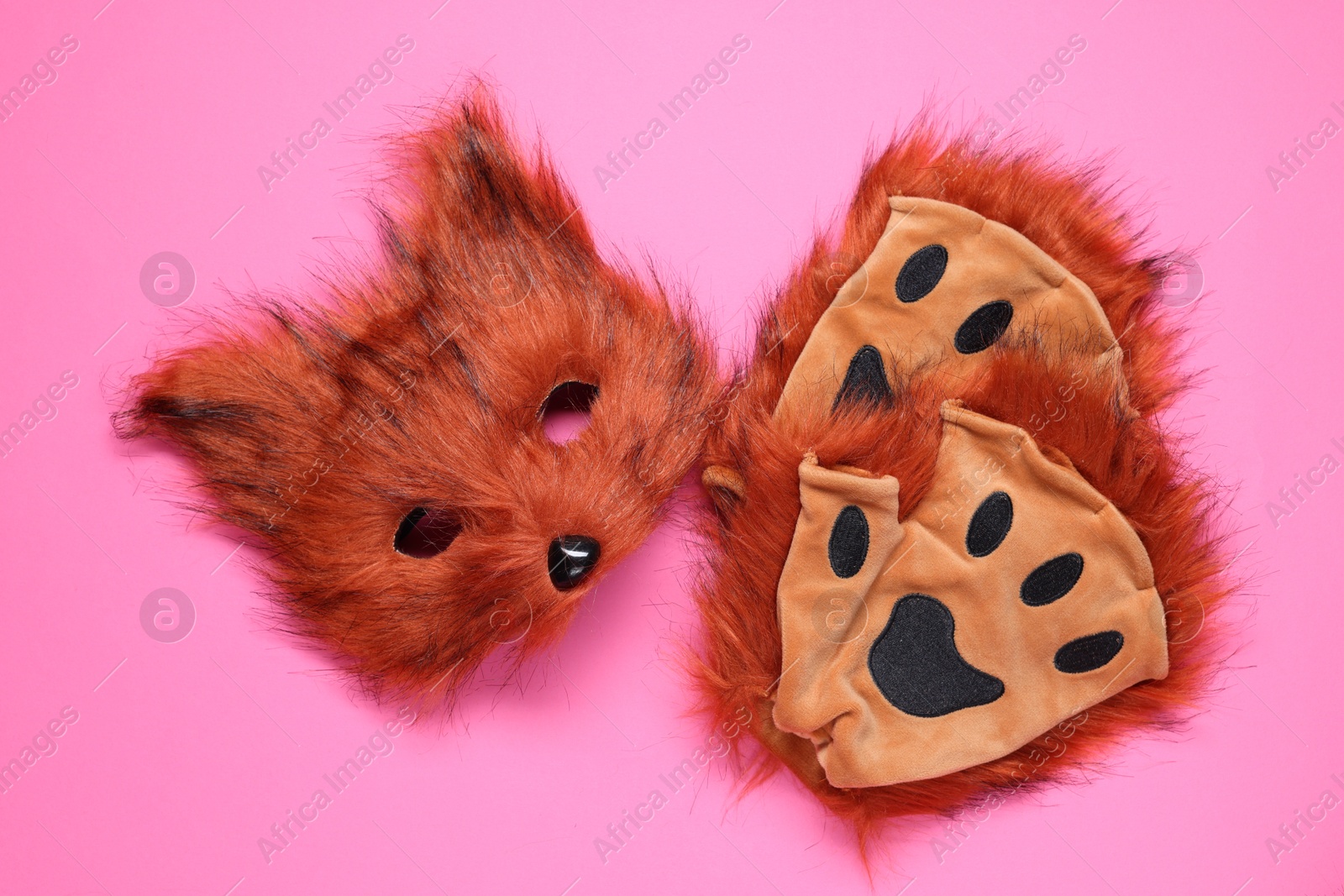 Photo of Quadrobics. Fox mask and gloves on pink background, flat lay