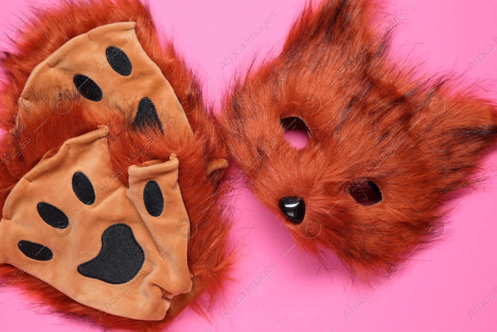 Photo of Quadrobics. Fox mask and gloves on pink background, flat lay