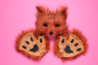 Photo of Quadrobics. Fox mask and gloves on pink background, flat lay