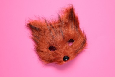 Photo of Quadrobics. Fox mask on pink background, top view