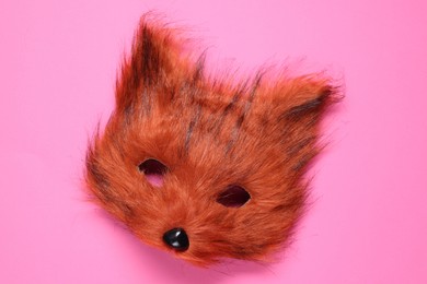 Photo of Quadrobics. Fox mask on pink background, top view