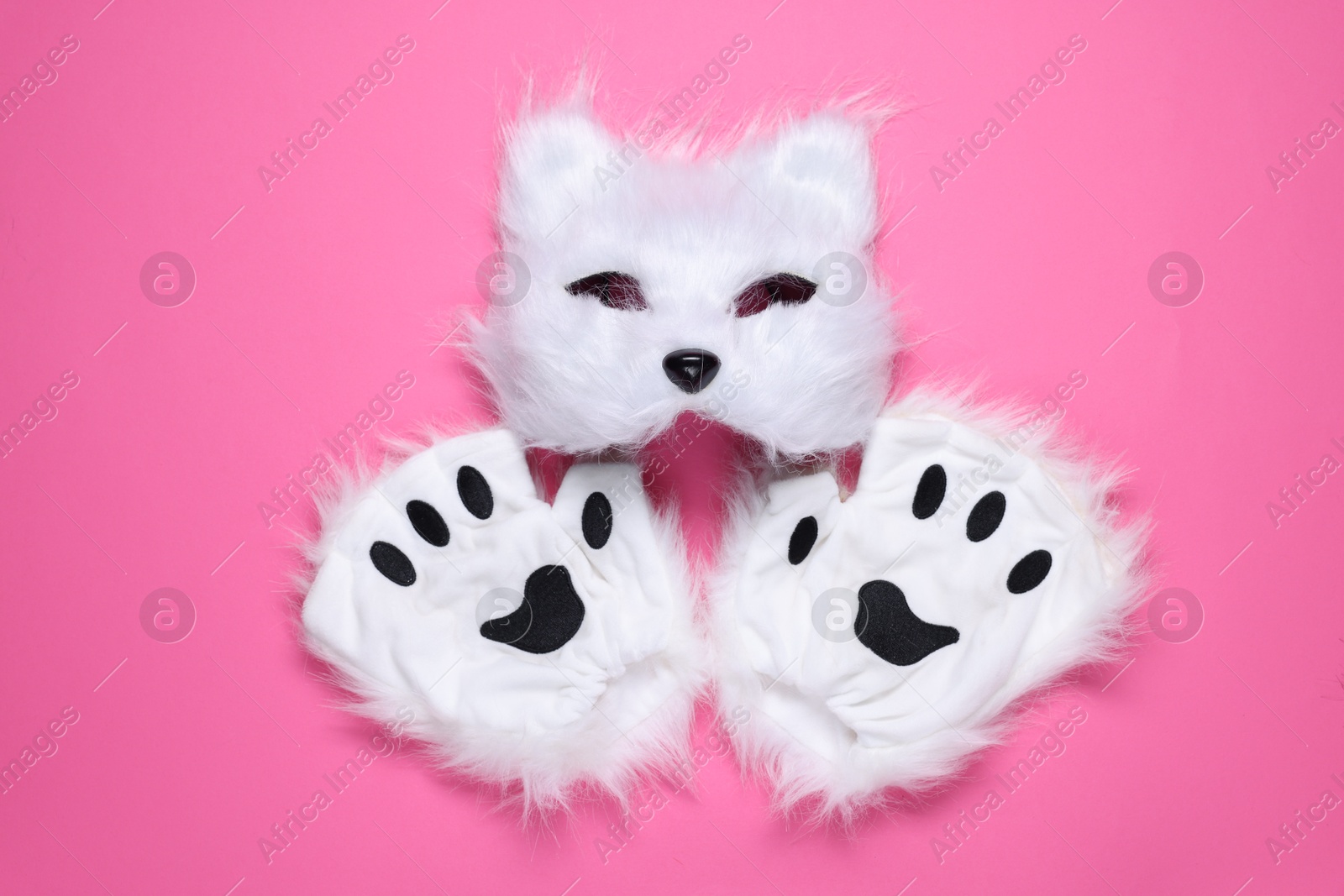 Photo of Quadrobics. Cat mask and gloves on pink background, top view