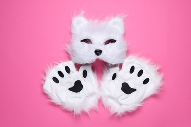 Photo of Quadrobics. Cat mask and gloves on pink background, top view