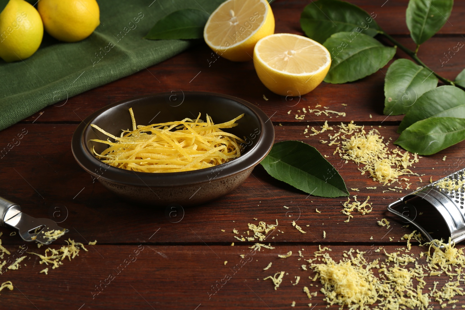 Photo of Lemon zest, tools and fresh fruits on wooden table