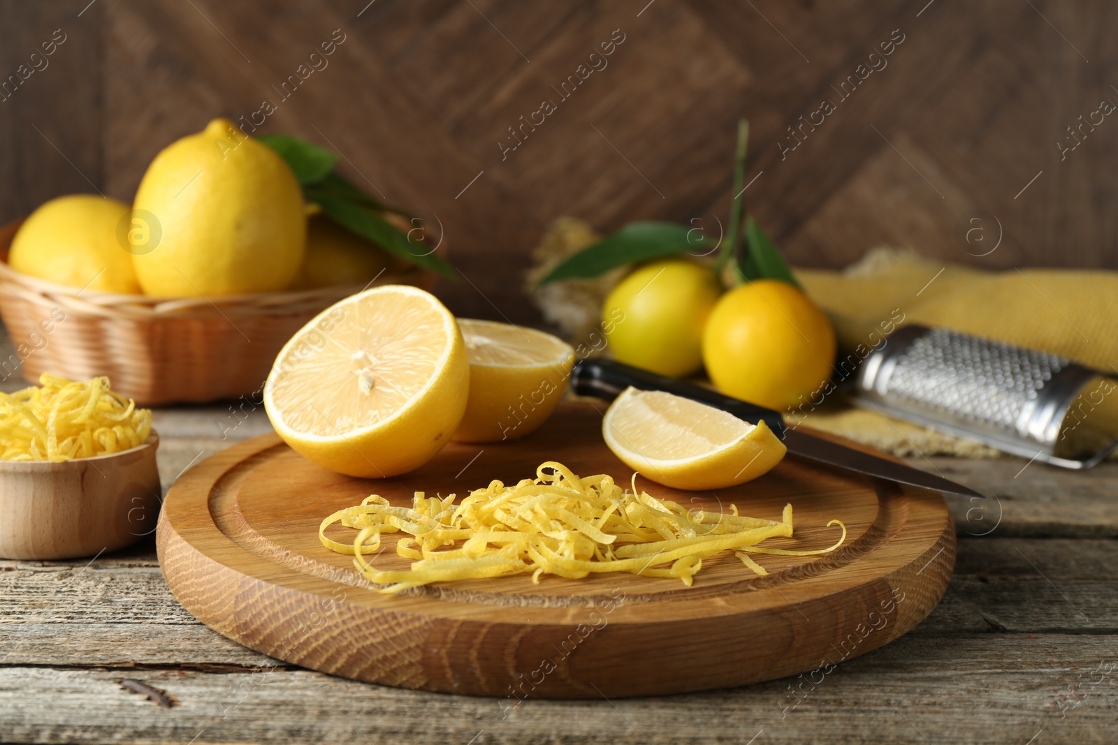 Photo of Lemon zest, tools and fresh fruits on wooden table