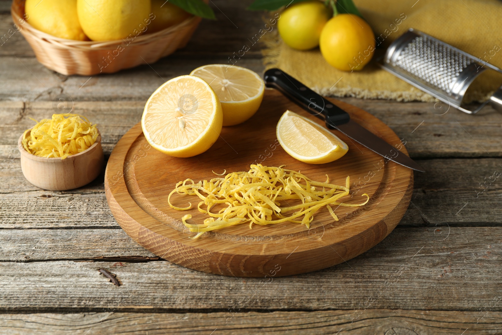 Photo of Lemon zest, tools and fresh fruits on wooden table