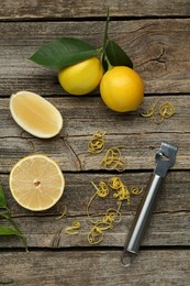 Photo of Lemon zest, zester tool and fresh fruits on wooden table, flat lay