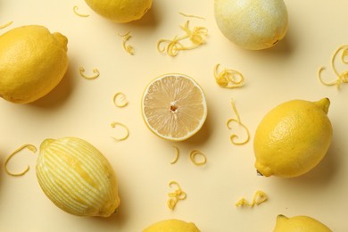 Photo of Lemon zest and fresh fruits on beige background, flat lay