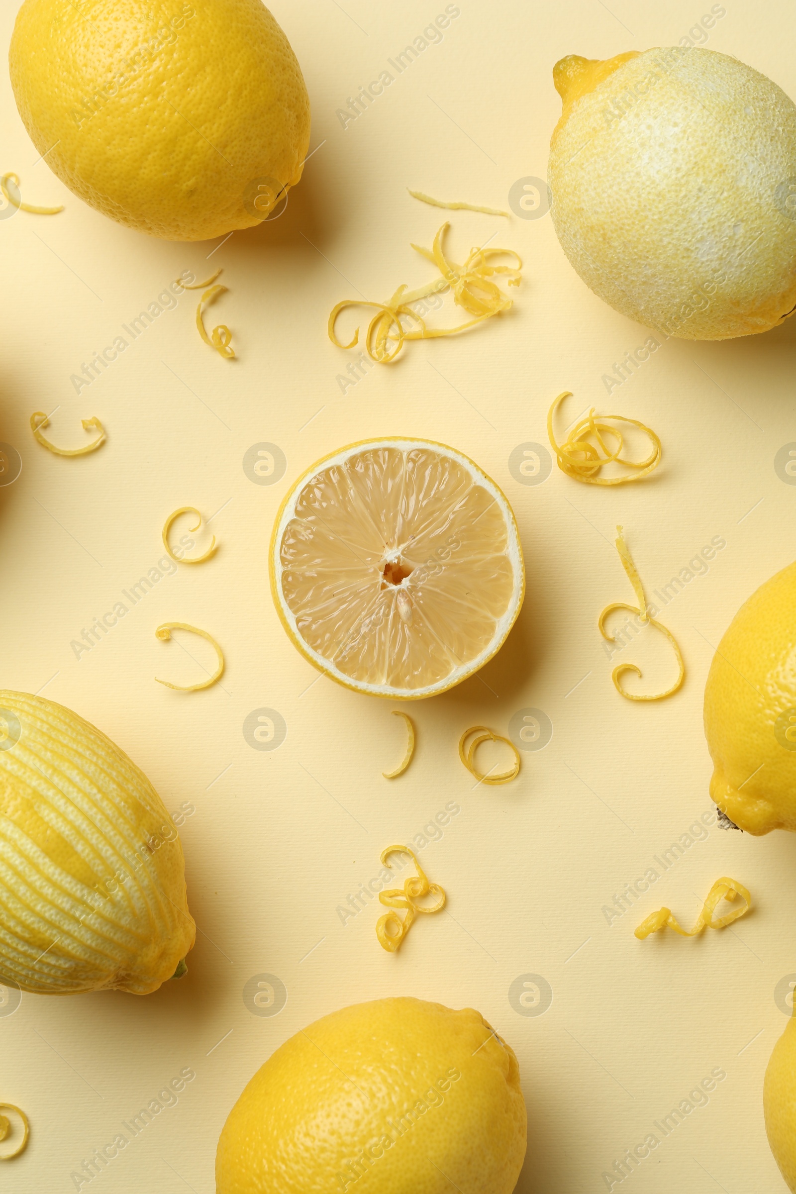 Photo of Lemon zest and fresh fruits on beige background, flat lay