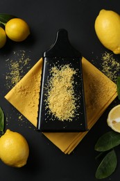 Photo of Grater with lemon zest, fresh fruits and leaves on black background, flat lay