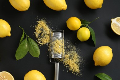 Photo of Grater with lemon zest, fresh fruits and leaves on black background, flat lay