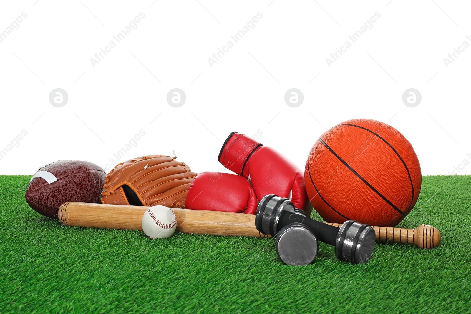 Photo of Different sport equipment on green grass against white background