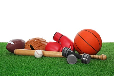 Photo of Different sport equipment on green grass against white background