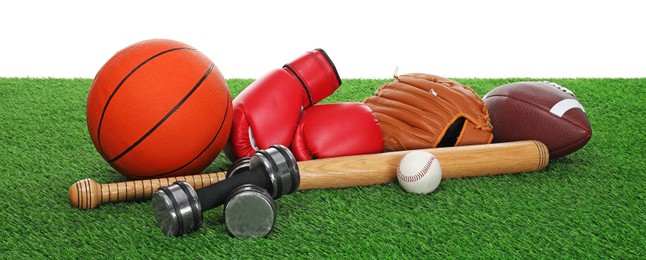 Photo of Different sport equipment on green grass against white background