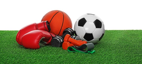 Photo of Different sport equipment on green grass against white background