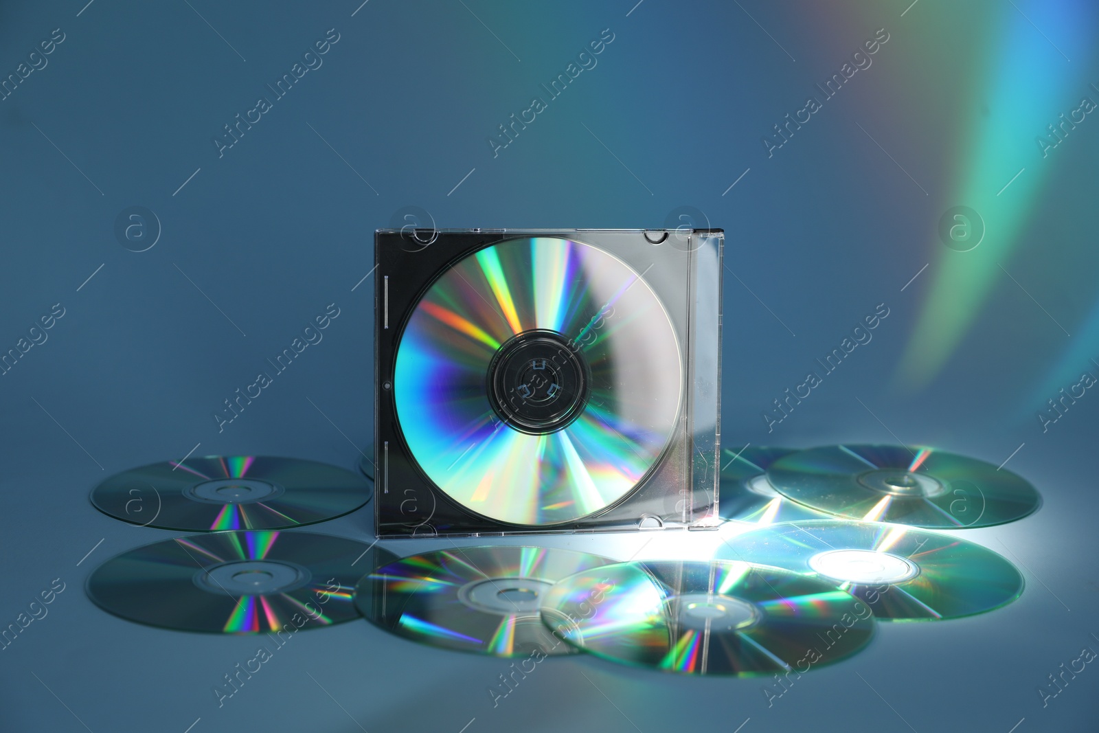 Photo of Many compact discs on light blue background