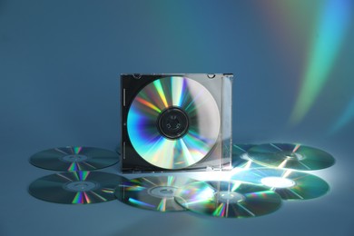 Photo of Many compact discs on light blue background