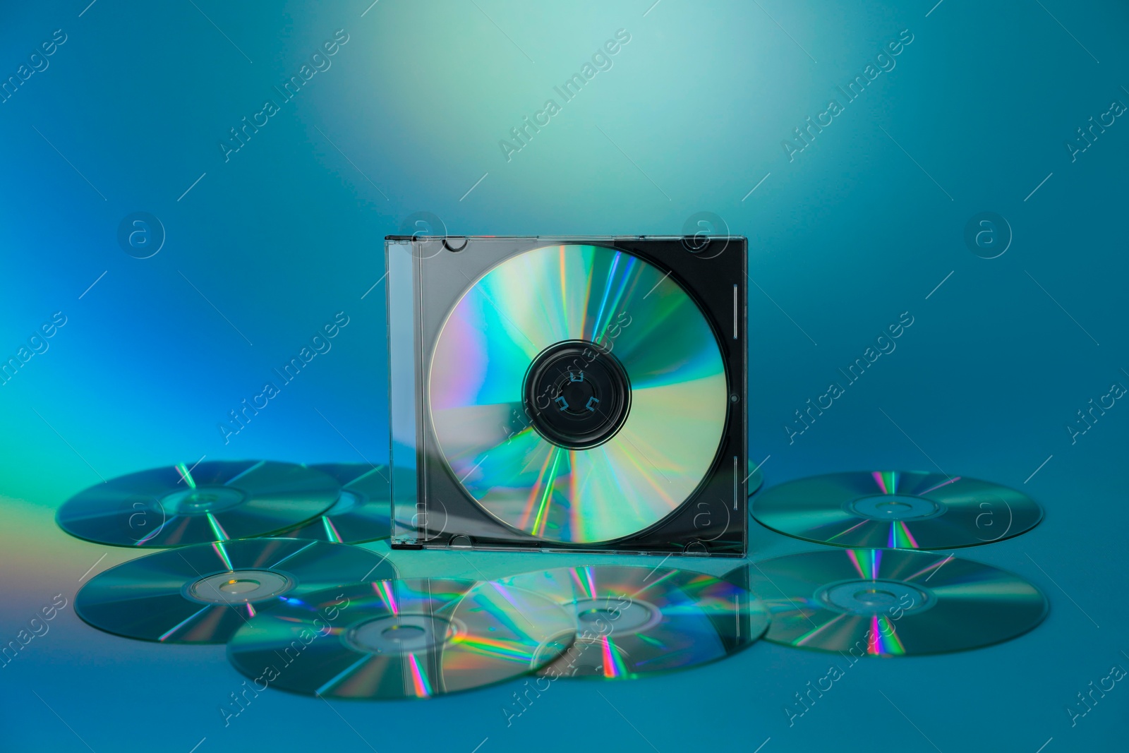 Photo of Many compact discs on light blue background