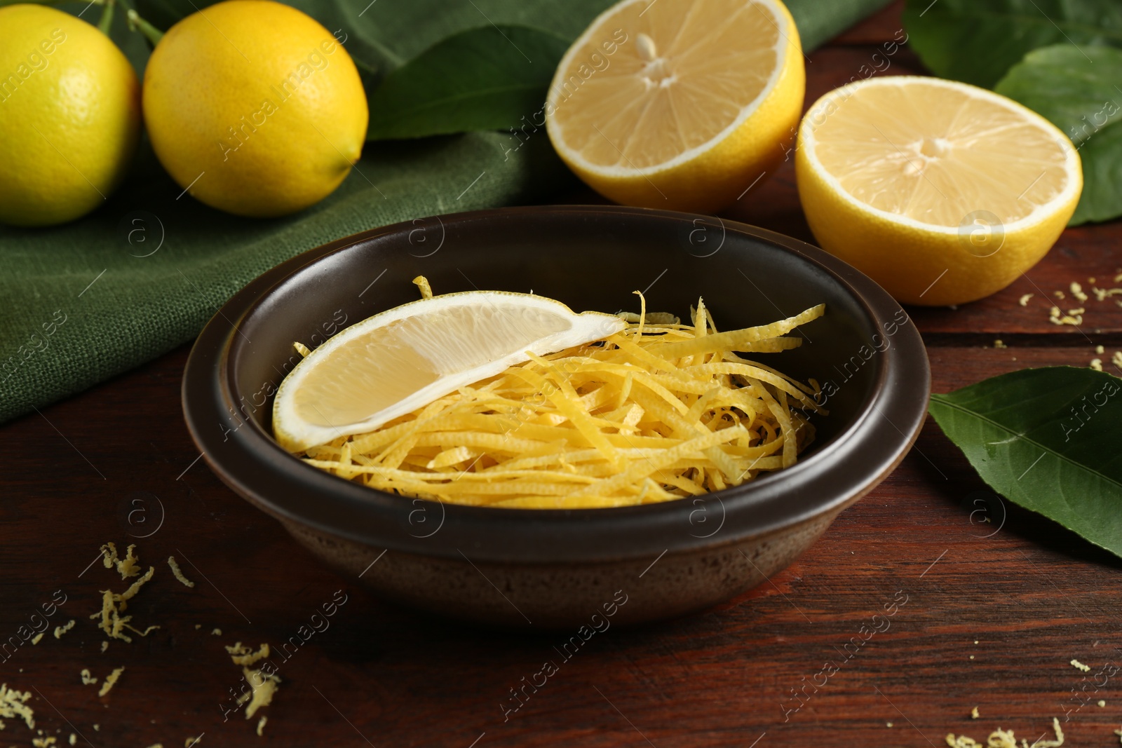 Photo of Lemon zest and fresh fruits on wooden table, closeup