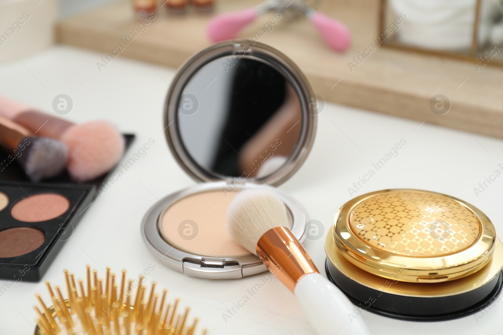 Photo of Makeup room. Different beauty products on white dressing table, closeup