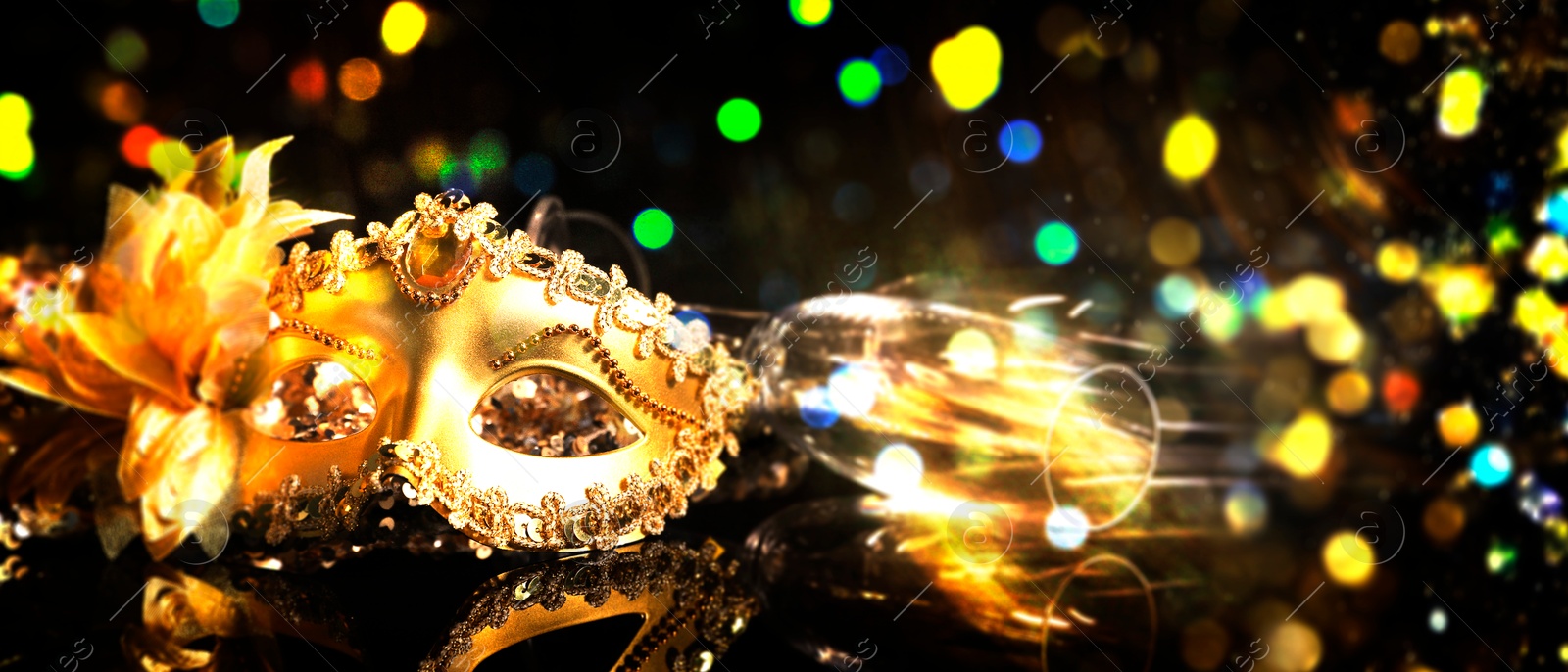 Image of Beautiful carnival mask and flute on black background with blurred lights, bokeh effect. Banner design with space for text