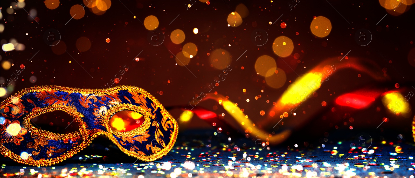 Image of Beautiful carnival mask on dark background with glitter, bokeh effect. Banner design with space for text