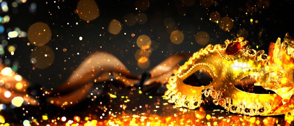 Image of Beautiful carnival mask on black background with glitter, bokeh effect. Banner design with space for text