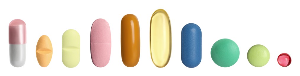 Image of Different pills in row isolated on white, set