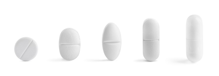 Image of Different pills in row isolated on white, set