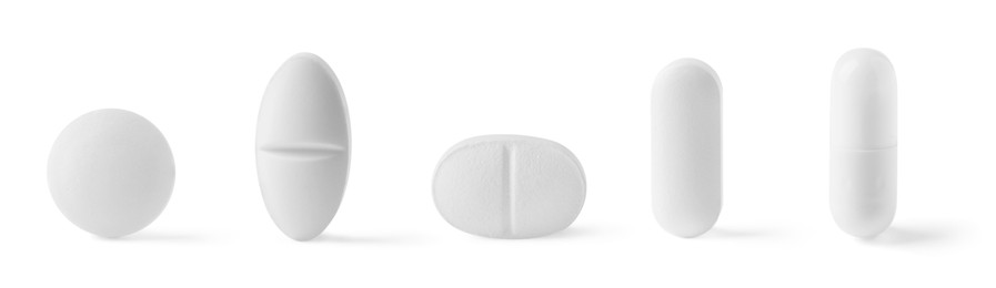Image of Different pills in row isolated on white, set