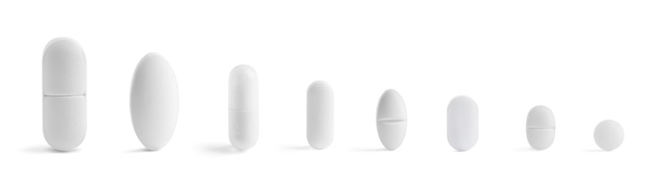 Image of Different pills in row isolated on white, set