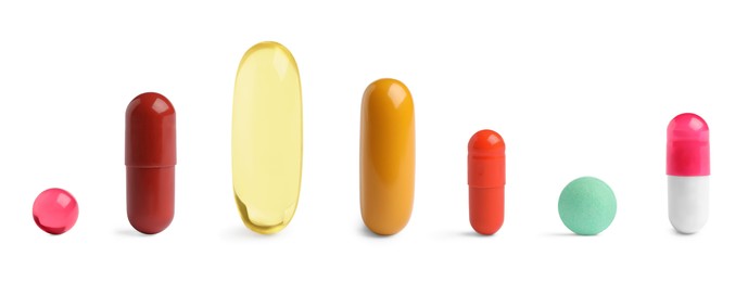 Image of Different pills in row isolated on white, set