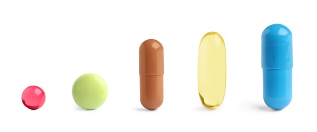 Image of Different pills in row isolated on white, set